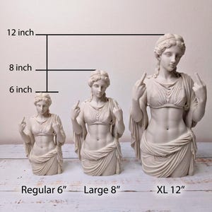May include: Three off-white statues of a figure in classical drapery, each displaying a middle finger gesture. The statues are labeled by height as Regular 6 inch, Large 8 inch, and XL 12 inch, with corresponding measurement lines indicating their sizes.