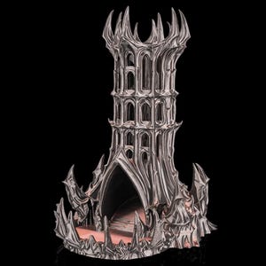 May include: A silver-colored, gothic-style tower sculpture with intricate architectural details. The tower features multiple levels with arched windows and a spiked crown. The base has a textured, fortress-like appearance, with a dark interior.