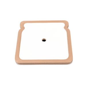 May include: A square, white cutting board with a tan, bread-shaped border. The cutting board has a small, black hole in the center. The board is on a white background.