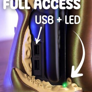 May include: A close-up of a device with the words "FULL ACCESS USB8 + LED" in white. The device has a USB port and a green LED light. The device is tan and gold in color.