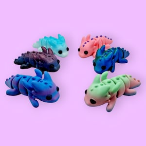 May include: Six small, colorful, hand-painted figurines of dragons with different color combinations, including blue, green, pink, and purple.