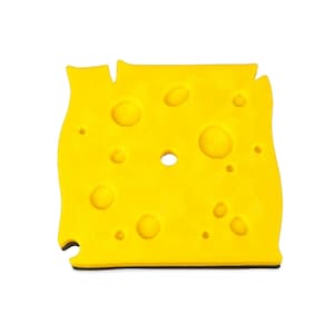 May include: A bright yellow, cheese-shaped object with multiple circular holes and a black base. The cheese has a slightly irregular shape, with a few notches along the edges, and is set against a white background.