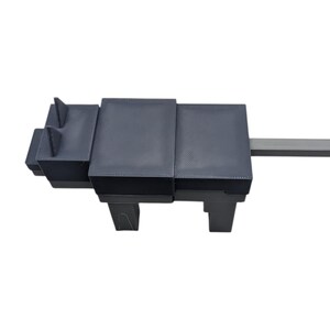 May include: A dark grey, geometric sculpture resembling an animal, possibly a dog or wolf. Constructed from rectangular blocks, it has a long, rectangular tail. The design is minimalist and contemporary, suitable for modern interiors. The sculpture is in the shape of a dog.