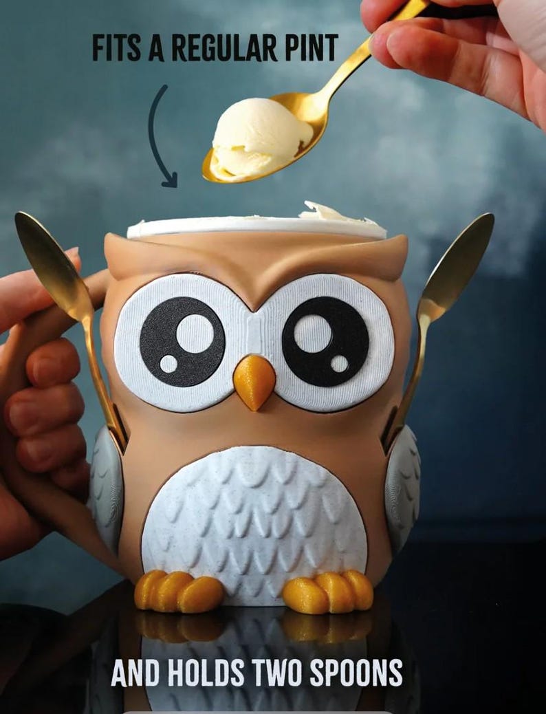 May include: An owl-shaped ice cream bowl with a lid, holding two gold spoons. The bowl is brown, white, and orange, with large black and white eyes. Text on the image reads "FITS A REGULAR PINT" and "AND HOLDS TWO SPOONS".