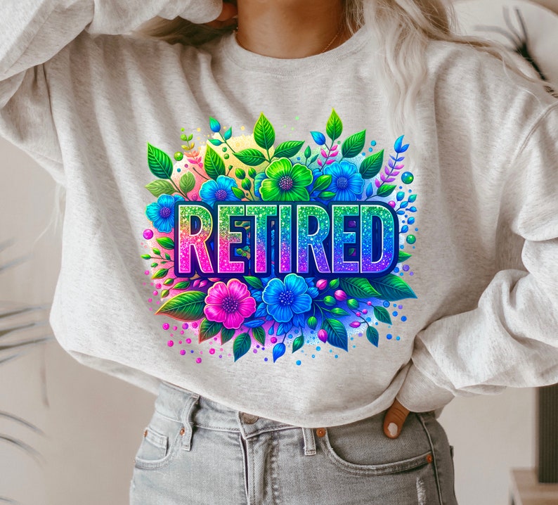 May include: A grey sweatshirt with a colourful floral design and the word "RETIRED" in rainbow glitter letters.