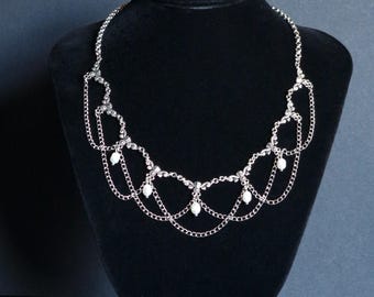 Elegant, Gothic inspired silver chandelier necklace with real pearls.