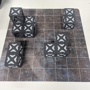 May include: Four gray and white modular storage containers on a gray and brown tiled surface. The containers are stacked and arranged in different configurations.
