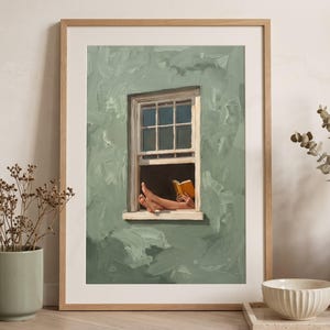 May include: A framed art print featuring a sage green wall with a white window frame. Inside the window, a pair of bare feet rest on the sill while a person holds an open orange book. The painting style uses visible brushstrokes throughout the wall.