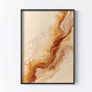 May include: Abstract art print in a black frame. The artwork features a flowing design with shades of beige, cream, and brown, creating a marbled effect. The colors blend together to form a unique, organic pattern, suitable for home decor.