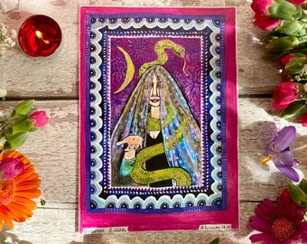 May include: A colorful illustration of a woman with a snake on her head. She is wearing a veil and a black dress. The background is purple with a crescent moon and stars. The text "Goddess Lilith" is written at the bottom left and "Rhiannon Hall" is written at the bottom right.