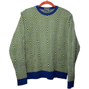May include: A long-sleeved sweater with a checkered pattern in shades of green and blue. The sweater has a crew neck and a blue band around the bottom. The text "VERSACE CLASSICS" is visible on the front of the sweater.