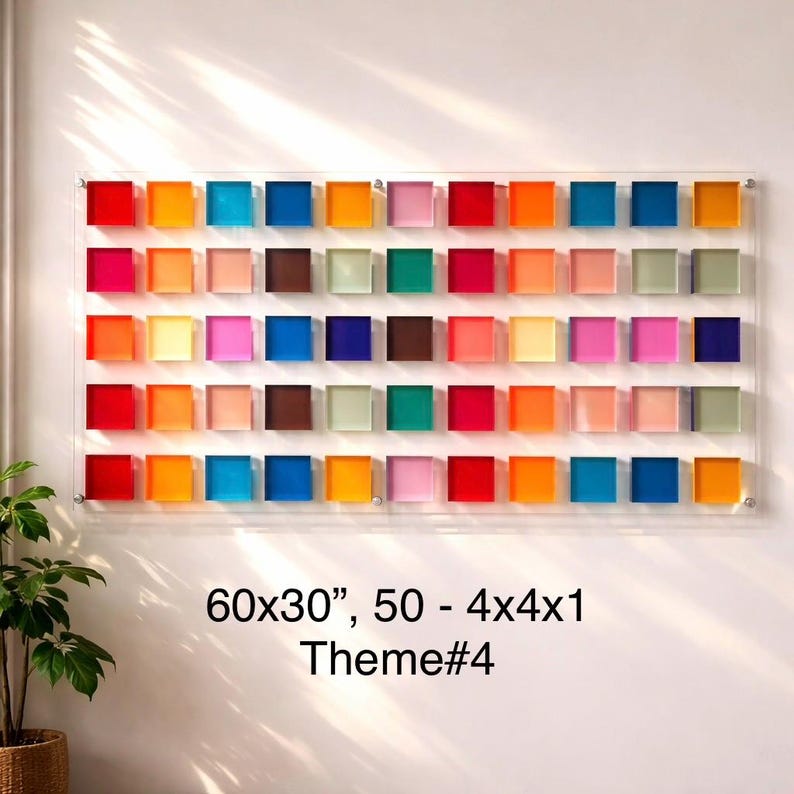 May include: A rectangular wall art piece featuring 50 colourful, square blocks in a grid pattern. The blocks are arranged in rows and columns, showcasing a vibrant spectrum of colours. The artwork measures 152x76 cm.
