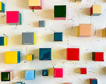 May include: A white background with colorful square blocks in various colors, including red, blue, green, yellow, and black. The blocks are arranged in a random pattern.