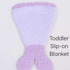 May include: A handmade, lavender and white crochet mermaid tail blanket for toddlers. The blanket features a textured stitch pattern and is designed as a slip-on style. Text on the image reads "Mermaid Tail Crochet Pattern" and "Toddler Slip-on Blanket."