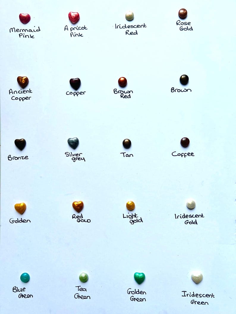 May include: A chart of 15 heart-shaped resin pieces in various colors, including mermaid pink, apricot pink, iridescent red, rose gold, ancient copper, copper, brown red, brown, bronze, silver grey, tan, coffee, golden, red gold, light gold, iridescent gold, blue green, tea green, golden green, and iridescent green.