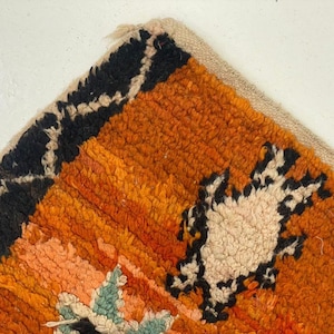 a close-up view of a vibrant, multicolored rug with a geometric pattern.