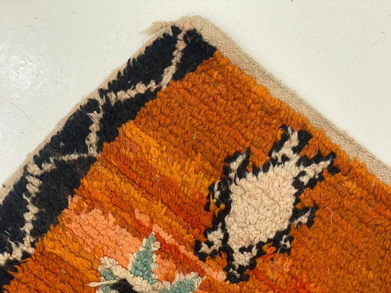 a close-up view of a vibrant, multicolored rug with a geometric pattern.
