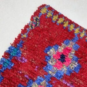 a vibrant, colorful rug with a red and blue floral pattern.