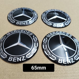 May include: Four black and silver Mercedes-Benz wheel centre caps with the Mercedes logo and "Benz" text. The caps are 65mm in diameter.