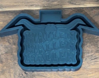 May include: Black silicone mold for making a Halloween-themed resin tray. The mold features the word "Halloween" repeated three times in a wavy font.