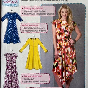 May include: McCall's sewing pattern M7382 for beginners. The package features illustrations of dresses, including a blue polka dot dress, a yellow dress, and a patterned dress. The package also includes the text "learn to sew for fun".