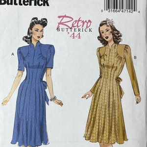 May include: Butterick sewing pattern B6485, showcasing retro dress designs. The pattern envelope shows illustrations of two dresses: a blue dress with a bow and a tan dress with a patterned design. The text "Retro Butterick '44" is also visible.