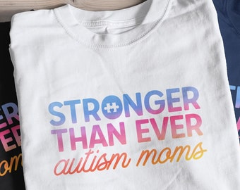 May include: Three t-shirts with a rainbow gradient design that reads "Stronger Than Ever Autism Moms". The shirts are black, white, and navy blue.