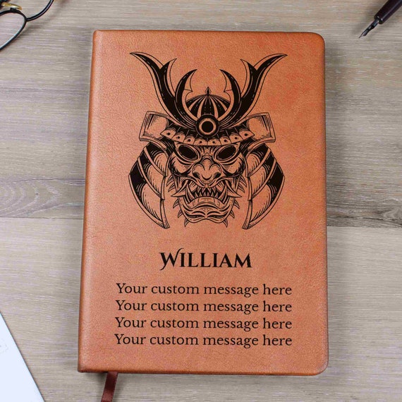 Hard-cover leather journal with a samurai-themed embossed design — the rare personalized notebook that doubles as a display object.