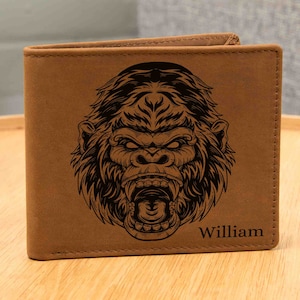 May include: Brown leather wallet with a black and white gorilla graphic and the name "William" engraved on the front.