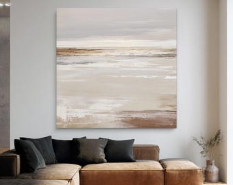 May include: Large abstract painting with a neutral color palette. The artwork features horizontal brushstrokes in shades of beige, brown, and gray, creating a serene landscape effect. The painting is displayed above a brown sectional sofa with black pillows.