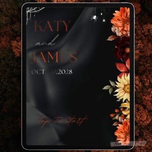 May include: A digital invitation on a tablet screen. The design features the names "KATY and JAMES" with the date "OCT .2028". Decorative elements include a spider web, spiders, and floral arrangements in orange, yellow, and burgundy against a black background. The words "Tap To Start" are also visible.