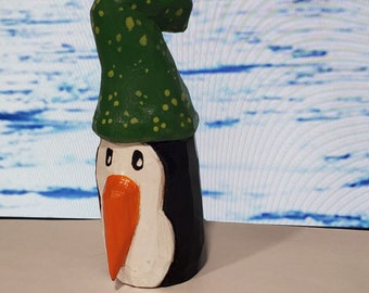 Hand made wood carved penguin in a green hat