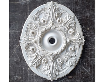 May include: White plaster ceiling medallion with a decorative, ornate design featuring a central circle and intricate leaf patterns.