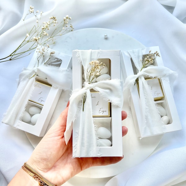Gift box with sugared almonds and chocolate wedding favors