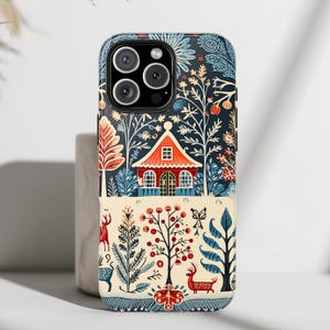 May include: A phone case featuring a colourful illustration of a house in a woodland setting. The design has a blue background with red, green and yellow accents. The house has a red roof and white trim. The woodland is filled with trees, flowers and birds.