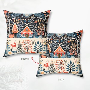 May include: Cushion with a folk art forest design. The pillow displays a red-roofed cottage, deer, and stylized trees on a dark blue backdrop. The front and back designs are shown, with the words "FRONT" and "BACK" visible.