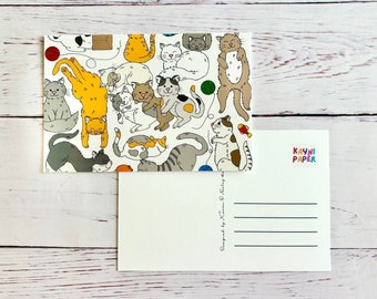 May include: A postcard featuring a colorful illustration of cats in various poses. The front of the card is covered in a repeating pattern of cats, while the back has a blank space for writing a message and a section for the recipient's address. The postcard is designed by Laura Eldridge and printed by Kayni Paper.