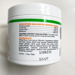May include: A white ceramic mug with a black handle and the text "But First, Coffee" in a bold, black font. The mug is set against a neutral background, highlighting its simple design.