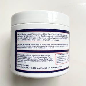 May include: A white plastic container of Maddie's American Ultra Easy Pill-Dough for pets. The label includes the product name, ingredients, and guaranteed analysis. The text also mentions the product is designed to hide pet medications.