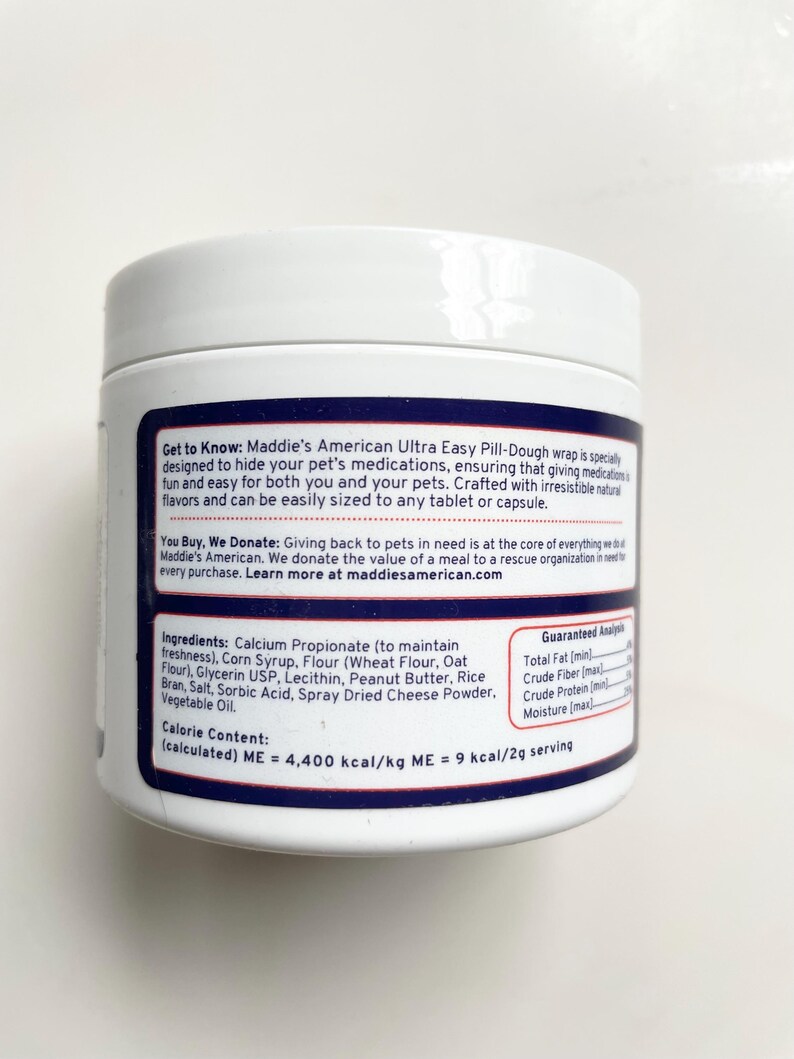 May include: A white plastic container of Maddie's American Ultra Easy Pill-Dough for pets. The label includes the product name, ingredients, and guaranteed analysis. The text also mentions the product is designed to hide pet medications.