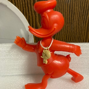 Marx Donald Duck with a 1940’s Huey Crackerjack Premium around his neck