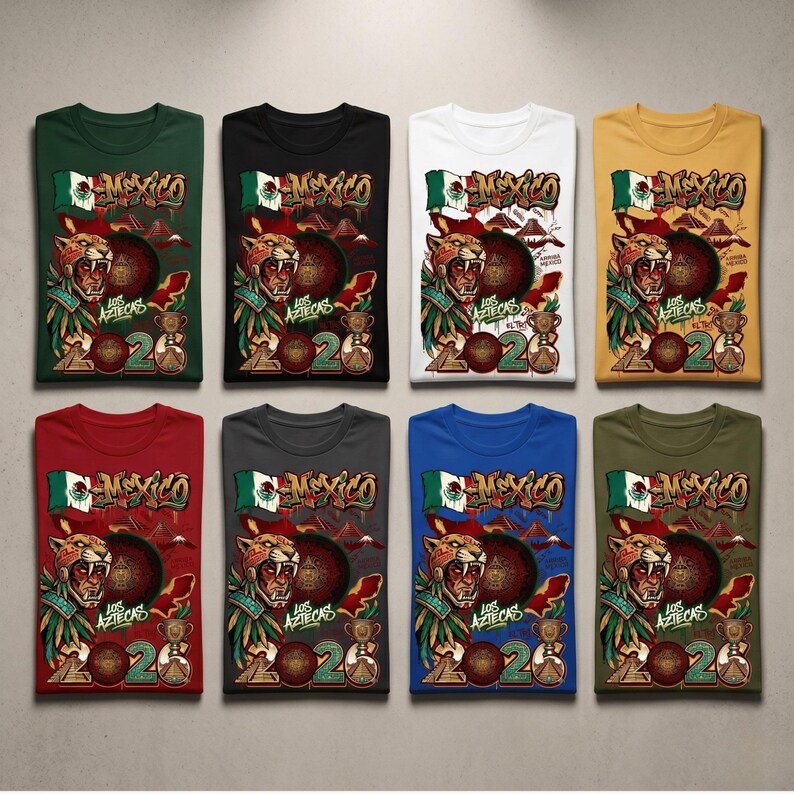 May include: Eight t-shirts in various colors, each featuring a graphic print of a jaguar warrior, the Mexican flag, a pyramid, a trophy, and the text "MEXICO", "LOS AZTECAS", and "2026". The shirts are arranged in two rows of four.