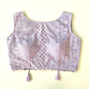 Dreamy Lavender shade chikanakari saree blouse. This is a sleeveless blouse and comes with pads and ties.