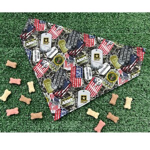 May include: A camouflage bandana with red, white, and blue American flags, military dog tags, and the words "Honor, Respect, Commitment, Army" printed on it.