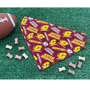 May include: A red and yellow dog bandana with the text "Central Michigan" and "Chippewas" repeated throughout the design.