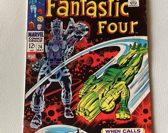May include: A comic book cover featuring the Fantastic Four, with the words "Fantastic Four" in large, yellow letters. The cover features a red, black, and white background with images of the Fantastic Four members, including the Thing, Mr. Fantastic, the Human Torch, and the Invisible Woman. The cover also features the words "When Calls Galactus!" in a white box.