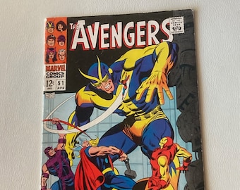 May include: A comic book cover featuring the Avengers, a group of superheroes. The cover features a yellow and blue superhero with a mask, and the text "THOR! IRON MAN! PLUS... THE RESTORED POWER OF... GOLIATH!"