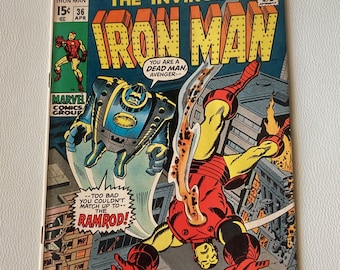May include: A comic book cover featuring Iron Man in a red and gold suit flying through the air. The cover text reads "The Invincible Iron Man" and "You are a dead man, Avenger--".