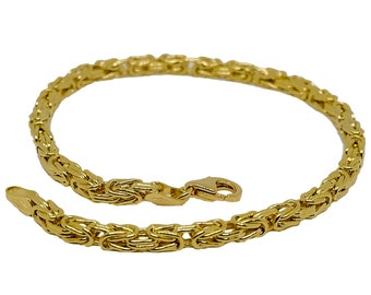 May include: A gold chain bracelet with a box clasp. The chain is made of a woven pattern.