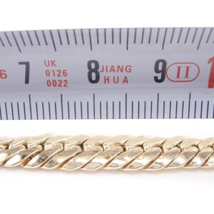 May include: A gold chain necklace measuring 9 inches in length. The chain is made of a twisted design.